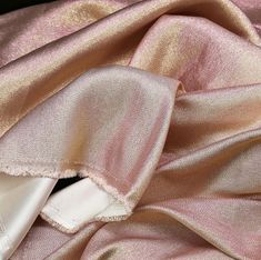 the fabric is pink and gold in color