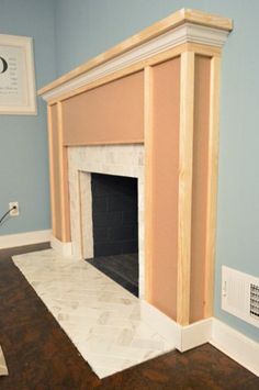 an empty living room with a fireplace in it