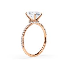 a rose gold engagement ring with an oval cut diamond and pave set side stones