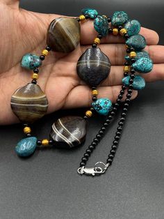 Ancient Natural Turquoise And Suleimani Yemeni Aqeeq Agate Stone Necklace With 18k Gold Plated Beads. Necklace Length 22 Inches. Shipping Payment Feedback & Return Policy 1 : We ship Monday to Friday Via Airmail Register Insured With Tracking # takes 2 to 4 Weeks to Destination. 2 : Contact us if you did not receive your item after 4 weeks.3 : We Accept Payment Only Via PayPal. 4 : In Any Inconvenience Case we do Accept Return and full Refund. 5 : We Ship worldwide via Airmail Registered with Tr Traditional Natural Gemstones As Gifts, Turquoise Agate Round Beads, Gems And Cabochons, Turquoise Agate Round Beads Gems And Cabochons, Turquoise Agate Round Beads For Crafting, Turquoise Agate Gemstone Jewelry, Traditional Turquoise Necklace With Natural Stones For Healing, Traditional Turquoise Necklace For Healing With Natural Stones, Traditional Turquoise Necklace For Healing, Turquoise Agate Gemstone Beads Necklace