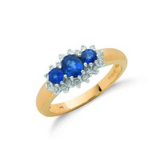 three stone sapphire and diamond ring in yellow gold