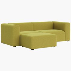 a green couch and ottoman sitting next to each other