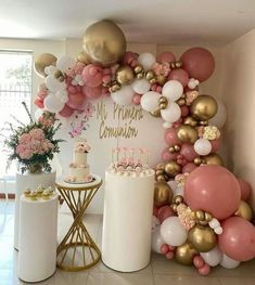 a room filled with balloons and cake on top of a table next to a wall