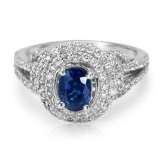 a blue sapphire and diamond ring with white diamonds on the sides, set in 18k white gold