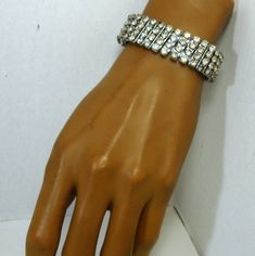 "SMALL SIZE, White Rhinestone Bracelet..Glam..Bling..Stretch metal, Lines and Lines of Glittery Sparkle Stones 1960s Glamorous A stretch metal Rhinestone bracelet, Diagonal rows of never ending stones: Sparkly White Rhinestones..bridal, wedding..Evening Bling eye candy. The bracelet stretches from 4 1/2\" at rest to just over 8.( 11.43cm out to 20.32cm ) It is 5/8\" wide of 4 Vertical rows of prong set or hand set shiny glass stones.( 1.68cm ) The stones vary in their clarity, 60% are very brigh Crystal Rhinestone Bracelet For Party, Costume Jewelry Crystal Bracelet With Rhinestones For Party, Costume Crystal Bracelet With Rhinestones For Party, Adjustable Bedazzled Formal Jewelry, Crystal Tennis Bracelet With Rhinestones For Party, Silver Crystal Bracelet With Stones For Party, Party Costume Jewelry Crystal Bracelet With Bling, Party Bling Crystal Bracelet Costume Jewelry, Sparkling Adjustable Tennis Bracelet For Party