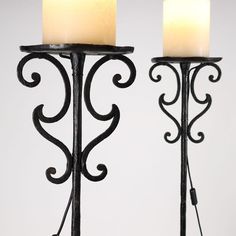 two lit candles are sitting on the stand