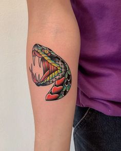 a colorful snake tattoo on the right arm and left arm with it's mouth open