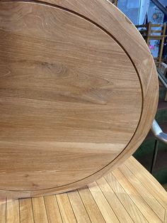 a close up of a wooden table with metal legs and an oval design on the top