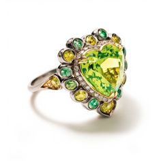 Peridot Floral Ring with neon yellow sapphires. Halo ring with yellow and green color theme made with precision cut peridot and yellow sapphires. Peridot, the bright green color of nature, is associated with harmony, good health, restful sleep, and peacefulness. Known as the stone of compassion, peridot calms anger by giving renewal to all things. When set in gold, this gem was said to protect the wearer from nightmares.  Inspired by the colors of early spring color, I put this together in flora Green Color Theme, Tree Jewelry, Pink Spinel, Floral Ring, August Birthstone, Spring Color, Jewelry Tree, Color Theme, Cute Rings