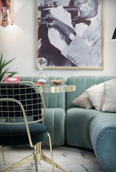 a living room filled with furniture and a painting on the wall