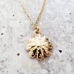 Step into a world of playful elegance with this Gold Dainty Daisy Charm Necklace. This adorable piece of jewelry is here to add a touch of enchantment to your everyday style. It's like capturing a piece of nature's cheerfulness and wearing it as a symbol of your vibrant spirit. This necklace brings a lighthearted touch to any outfit, whether you're dressing up for a special occasion or adding a playful accent to your casual look. Its dainty design and shimmering gold finish effortlessly elevate Delicate Nickel-free Flower Pendant Charm Necklace, Delicate Flower Pendant Charm Necklace, Nickel Free, Gold Plated Nickel-free Charm Necklace For Gift, Gold Plated Jewelry With Delicate Chain And Flower Pendant, Flower Pendant Metal Jewelry As Gift, Flower Pendant Metal Jewelry Gift, Metal Flower Pendant Jewelry For Gifts, Metal Flower Pendant Jewelry As Gift, Mother's Day Gold Plated Flower-shaped Jewelry