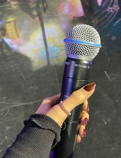 a person holding a microphone in their hand