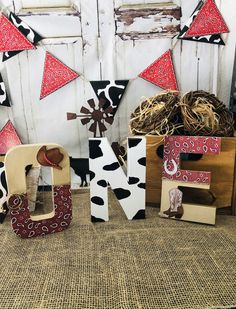 the letters are made out of wood and decorated with cow print