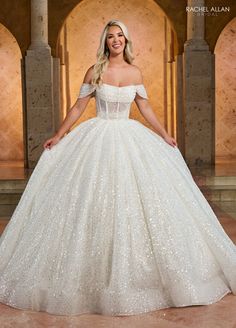 a woman in a wedding dress posing for the camera with her hands on her hips