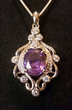 "Beautiful Purple Alexandrite Color Changing From Purple To Magenta Lab Grown Stone 8x10mm In Vintage Style Rococo Sterling Silver Chandelier Design Necklace. 18-20\" Sterling Chain." Oval Pendant Jewelry With Accent Stones For Gift, Classic Gemstones With Diamond Accents For Gift, Classic Gemstones With Diamond Accents As Gift, Dazzling Gemstones With Diamond Accents As Gift, Silver Necklaces With Accent Stones For Gifts, Elegant Purple Gemstones With Stone Setting, Elegant Hallmarked Gemstones For Jewelry Making, Elegant Gemstones With Accent Stones For Gift, Elegant Gemstones With Accent Stones As Gift