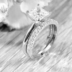 a close up of a ring with a flower in the background