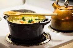 a pot filled with soup sitting on top of a stove