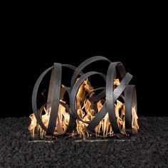 an outdoor fire pit with flames and rocks