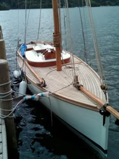 a sailboat docked at a dock in the water