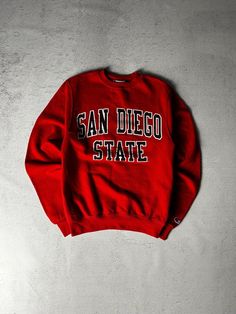 Vintage Champion San Diego State Crewneck Sweatshirt, Vintage Sweatshirt, Champion Sweatshirt Men's XS Size On Label: XS Recommended Size: Men's XS Measurements: Pit-to-Pit: 18" Length: 26" Collegiate Winter T-shirt For Streetwear, Streetwear Tops With Embroidered Logo, Embroidered Logo Tops For College Style Streetwear, College Fan Apparel Sweatshirt With Logo Print, University Red Crew Neck Top For Streetwear, Winter College T-shirt With Logo Print, Collegiate Crew Sweatshirt With Logo Print, College Crew Sweater With Logo Print, University Red Crew Neck Hoodie For Sports