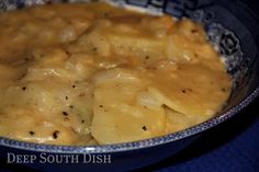 a bowl filled with food on top of a blue table cloth covered in gravy