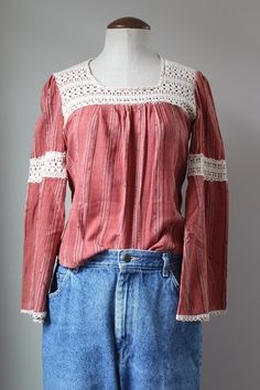 "Cutest vintage hippie blouse from the 70s! Intricate, hand crocheted lace - this would have taken a LONG time to make by hand. Slight bell sleeves and billowy empire waist. Cozy cotton blend fabric. 50% cotton, 50% polyester. Dark pink/red color. Label is faded, no brand or sizing legible. Estimated size S. Please see measurements for accurate fit. Measurements (taken laid flat, doubled where necessary): Length: 21\" Shoulders: 14\" Chest: 34\" Sleeve length: 22\" Condition: Excellent vintage c Bohemian Crochet Top With Crochet Trim For Fall, Bohemian Tops With Lace Patchwork For Fall, Bohemian Lace Patchwork Tops For Fall, Bohemian Long Sleeve Lace Top With Crochet Trim, Bohemian Lace Top With Crochet Trim And Long Sleeves, Bohemian Crochet Lace Blouse For Fall, Fall Bohemian Crochet Lace Blouse, Bohemian Cotton Peasant Top With Lace Trim, Bohemian Cotton Blouse With Lace Patchwork