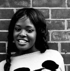 a black and white photo of a woman wearing a panda sweater