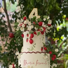 a white cake with strawberries and flowers on it