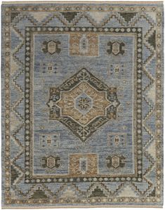 a blue and beige rug with an intricate design on the center, surrounded by smaller squares