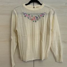 Beautiful vintage sweater in excellent vintage condition with no known flaws.  Size small, see pics for measurements. Front length is 21". Small button closure in the back.  IMPORTANT: My items are vintage. As with any pre-owned item, there will be varying degrees of wear - especially the older antique pieces. I do my best to point out any flaws, defects or wear issues, and supplement with pictures. To reduce wear and tear on vintage clothing, I do not usually wash items first. I leave the cleaning of these fun pieces to the new owner. I hope that I have done everything possible to make your buying experience a pleasure. If you receive something and notice that I have missed something or made a mistake, please contact me so I can quickly rectify any issues. I do not accept returns or excha Vintage Embroidered Fall Sweater, Retro Embroidered Crew Neck Sweater, Vintage Cream Sweater For Spring, Vintage Embroidered Crew Neck Sweater, Retro Embroidered Fall Sweater, Retro Embroidered Sweater For Fall, Fitted Vintage Cream Sweater, Vintage Embroidered Sweater For Spring, Vintage Embroidered Tops For Fall