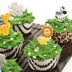 several cupcakes decorated with animals and plants