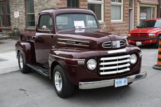 an old truck is parked on the street