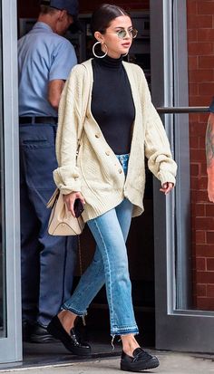 an image of a woman walking out of a building with her hand in her pocket