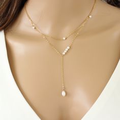 Introducing our Chantal Pearl Lariat Necklace, a delicate and versatile piece perfect for brides. The Y-shaped design, graced with tiny freshwater pearls, adds a touch of elegance, its timeless design and adjustable chain make it a perfect accessory to match any bridal style or bridesmaid look. Our Chantal necklace is perfect for stacking with other necklaces of different lengths, or matching with the Cora Bracelet D E T A I L S The drop measures about 2.5" Genuine Freshwater pearl measures 4-7mm Available in Sterling Silver ∙ 14K Gold Filled Adjustable chain 16 inches to 18 inches Hypoallergenic, lead-free & nickel-free. Our cultured pearls are carefully selected for their bright and lustrous qualities meaning the size, shape, and color may vary Handmade with love in our Florida studio Yo Dainty Pearl Necklace, Pearl Lariat Necklace, Bridal Party Attire, Pearl Lariat, Gold Lariat Necklace, Silver Pearl Necklace, Dainty Chain, Station Necklace, Pearl Set