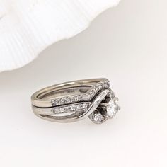 This previously loved ring is sure to make a statement with its round diamond center stone, embellished with beautiful diamond accents along the crossover shank in solid 14k white gold. Designer Silver Jewellery, Jewelry Showcases, Pendant Bracelet, Earring Findings, Diamond Wedding, Diamond Wedding Rings, Estate Jewelry, Round Diamonds, Ring Earrings