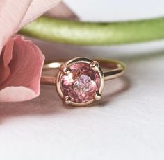 Custom cut by a local lapidary artist, the Floriane Pink Tourmaline is absolutely breathtaking. She majestically is designed with a halo basket setting and 1.3ct round pink tourmaline, making her a truly remarkable engagement ring. Floriane Pink Tourmaline Engagement Ring 14k Yellow Gold 1.3ct Round Pink Tourmaline Custom Cut by local lapidary artist Halo Basket Setting 1.5mm Round Smooth Band Pink Tourmaline Engagement Ring, Pink Engagement Ring, Tourmaline Engagement Ring, Basket Setting, Pink Morganite, Pink Gemstones, Perfect Engagement Ring, Pink Diamond, Perfect Ring