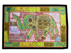 an elephant is painted on a patchwork wall hanging