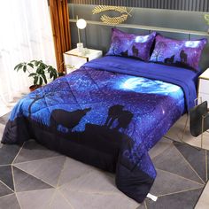 a bed with purple and blue comforters on top of it next to a night sky