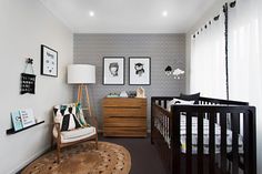 a baby's room with two cribs and pictures on the wall