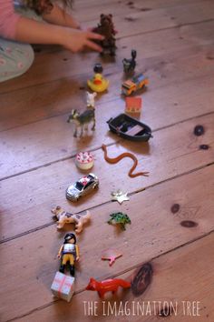 a child is playing with toys on the floor in front of her and other children's toys