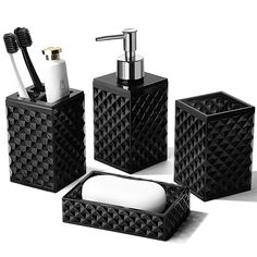 three black bathroom accessories including soap dispenser and toothbrush holder