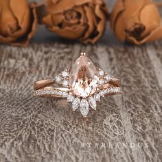 an engagement ring with a pear shaped morganite surrounded by diamonds