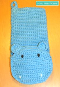 a crocheted cell phone case with a hippo face on it's side