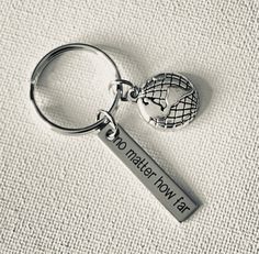 a metal keychain with the words no matter how far it is on it