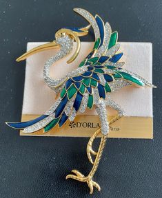 La Scala Signature Bird Brooch.  Triple 22kt gold plated w handset Swarovski crystals and hand painted blue & green enamel.  New Brooch. Luxury Gold Enamel Brooch, Luxury Gold Enamel Brooches, Luxury Enamel Pin For Formal Occasions, Luxury Enamel Brooches For Formal Occasions, Luxury Formal Enamel Pin, Luxury Gold Enamel Pin For Formal Occasions, Luxury Gold Enamel Pin As Gift, Luxury Gold Enamel Pin For Gift, Luxury Gold Enamel Pin Gift