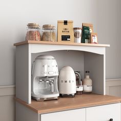 the coffee maker is sitting on top of the counter next to the spice and seasoning bottles