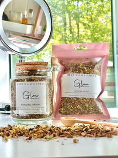 a jar filled with granola next to a mirror