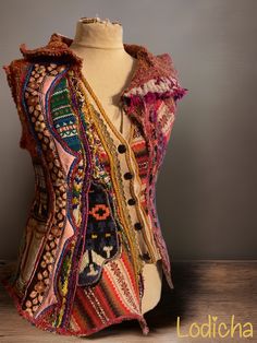 a mannequin wearing a multicolored vest with buttons and fringes on it