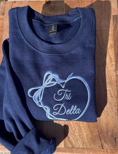 a blue sweatshirt with the words ti deletta on it and an apple in front