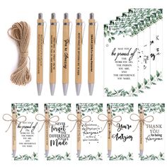 the wedding stationery is set up with four pens and two envelopes, tied in twine